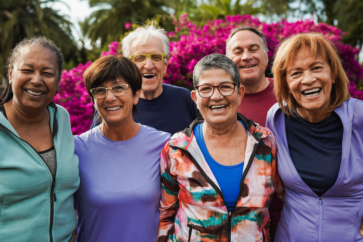 Group of senior friends smiling on camera after yoga lesson at city park About Us | AVIVA Granbury Senior Living